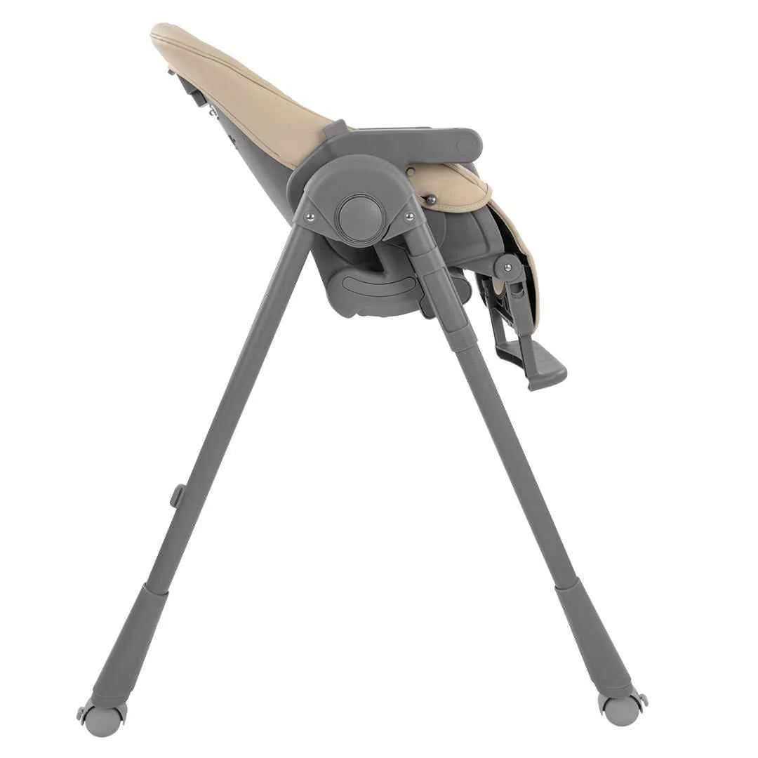 Beige high chair with reclined seat, side tray, and four rolling legs in gray
