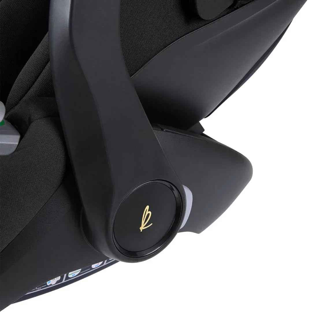 Car seat adjustment knob on dark base, with padded side support