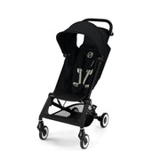 Black compact stroller with canopy, front wheels with suspension, and reclining seat