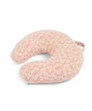 Nursing pillow in peach with white peony-style floral print, U-shaped with arm support