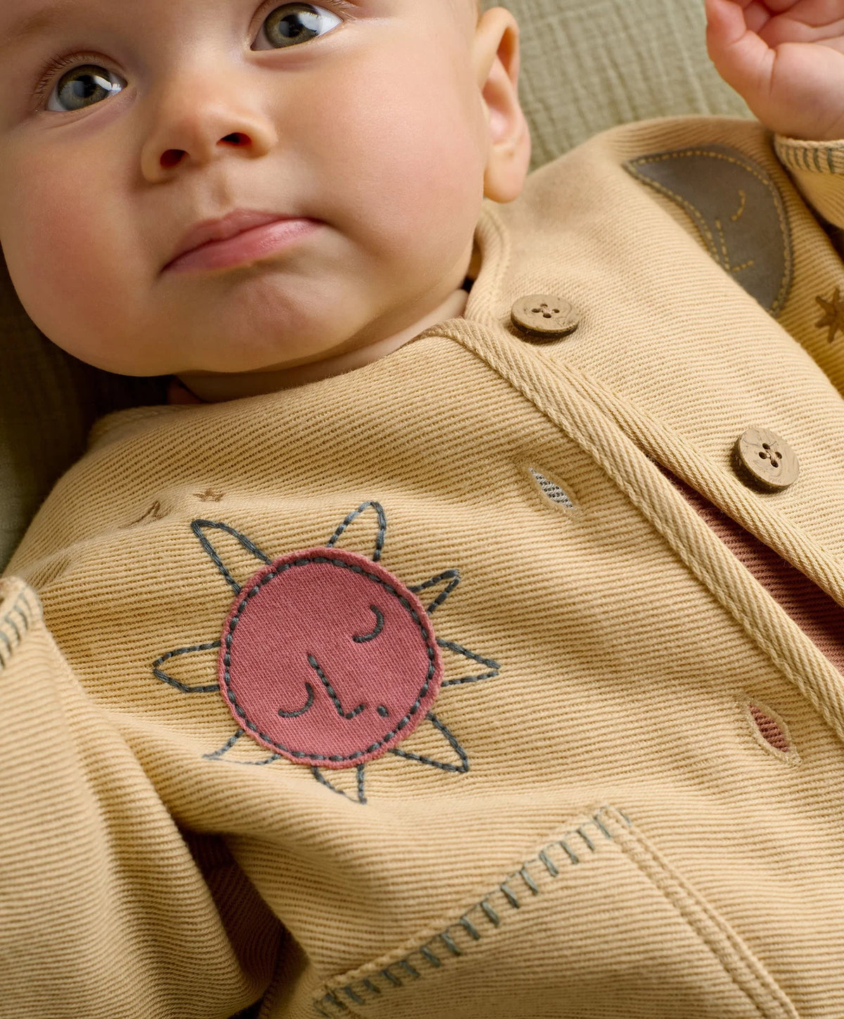 Cream kids jacket with embroidered smiling sun patch and buttoned front