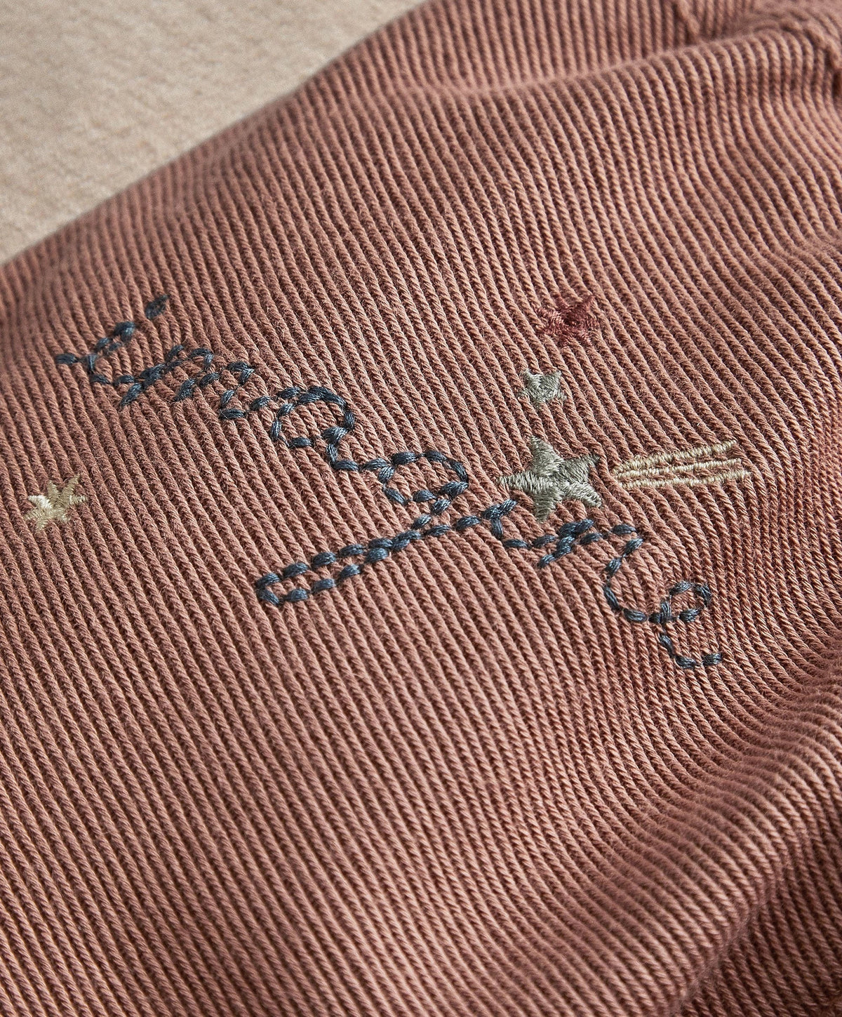 Applique trousers side embroidery with small stars and a stitched blue decorative line
