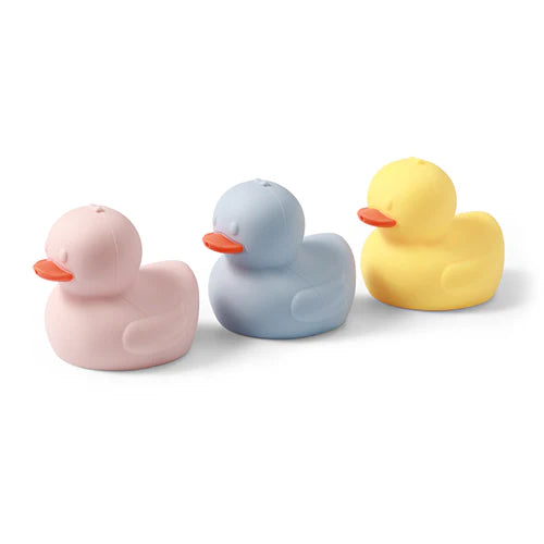 Three silicone bath duck toys in pink, light blue, and yellow