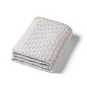 Grey cotton knitted blanket with textured chevron stitch, neatly folded