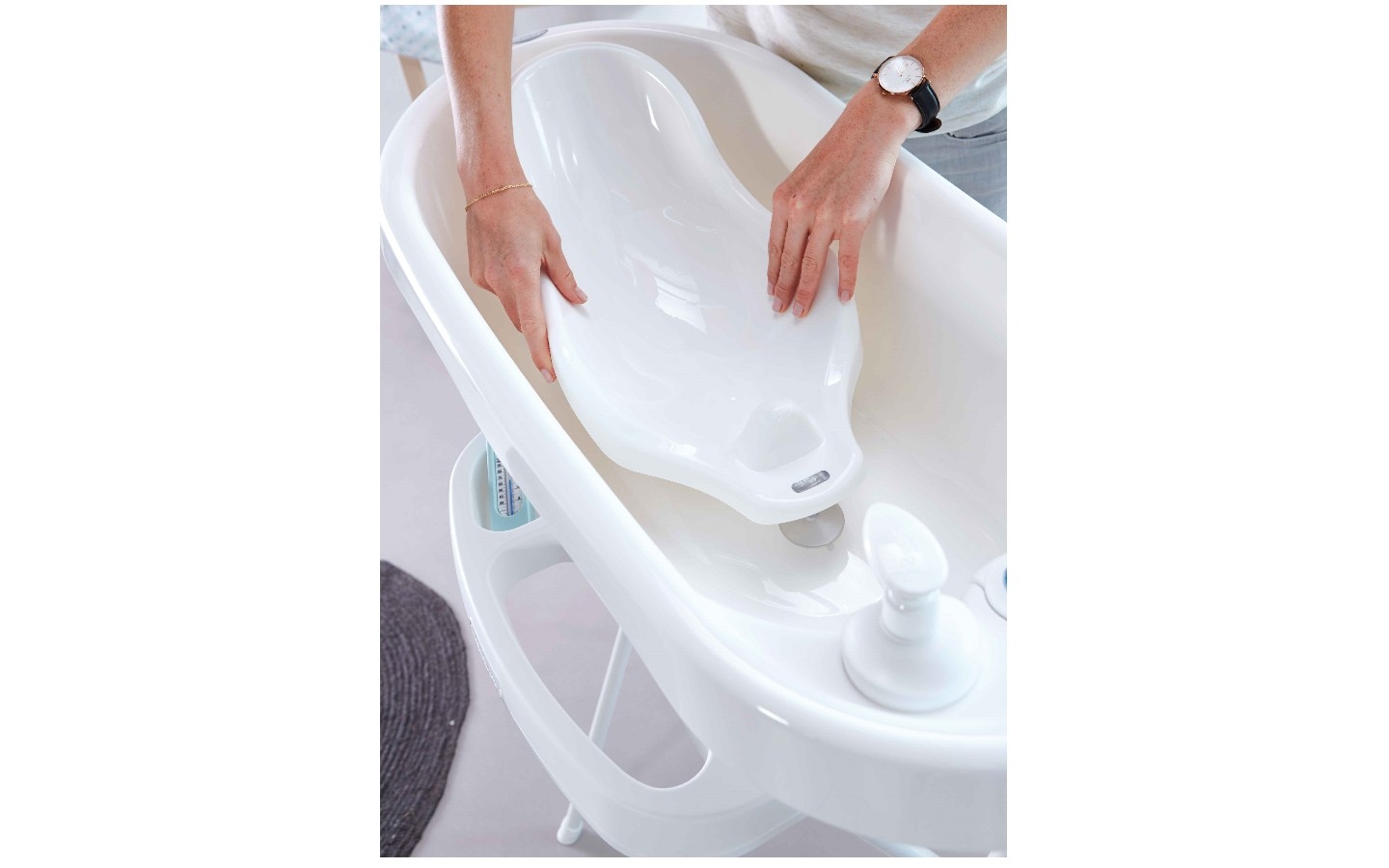 White bathtub with faucet knobs and drain area, temperature dial visible