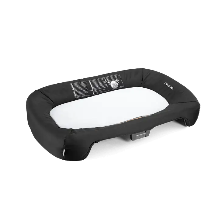 Dark bassinet insert cushion with oval shape, nuna logo and label on top