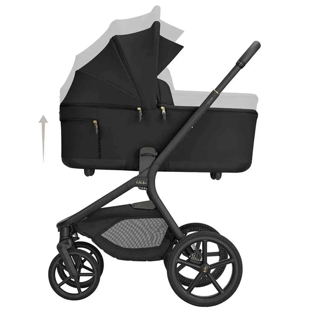 Black carrycot on stroller frame with large wheels and front mesh panel