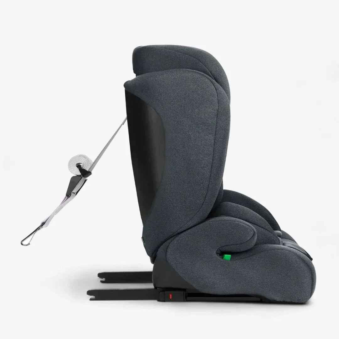 Dark grey car seat side view with seatbelt and padded headrest
