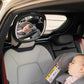 LED rearview car mirror mounted inside car, circular lens showing rear-seat baby
