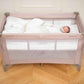 Grey 2-level baby cot with baby lying on a white fitted mattress