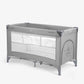Grey 2-level baby cot with open mesh sides and padded top rail