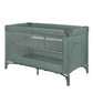 Green baby cot with mesh side panels and fabric top rail
