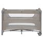 Beige two-level baby cot with mesh and fabric panels, standing on caster wheels
