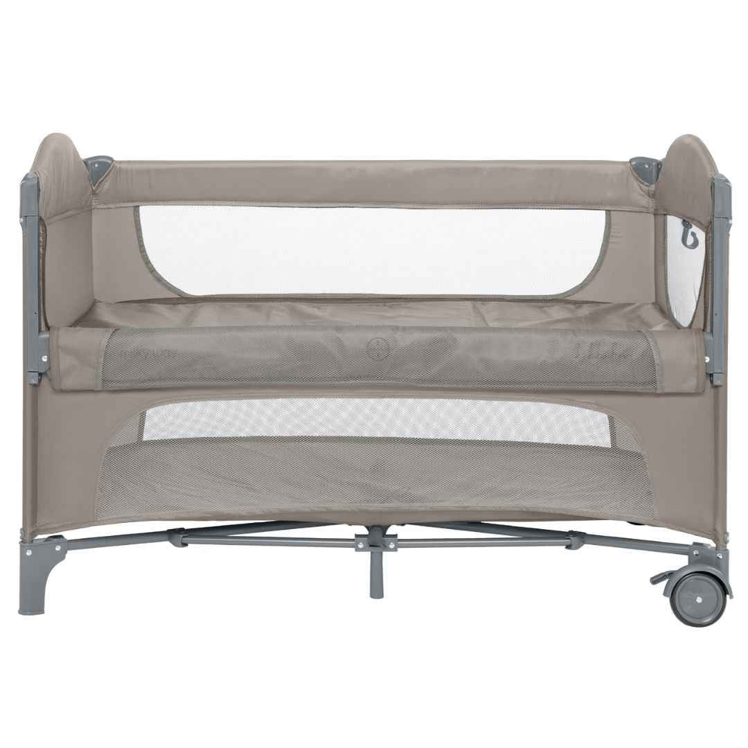 Beige two-level baby cot with mesh side openings and padded mattress platforms