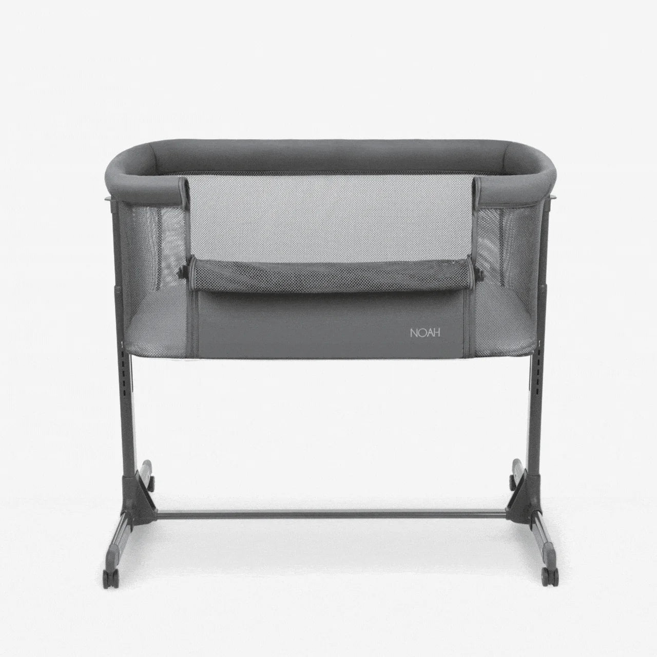 Dark grey bedside crib with mesh panels, padded rim, and four rolling feet