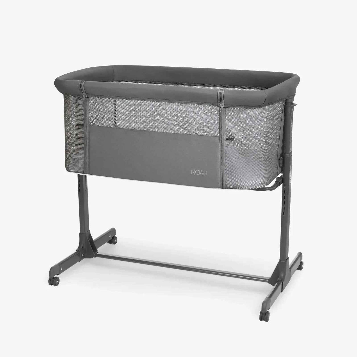 Dark grey bedside crib with padded top, mesh sides, and wheeled aluminum frame