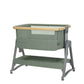 Army green bedside crib with open view, white mesh panel, wooden top rail, casters