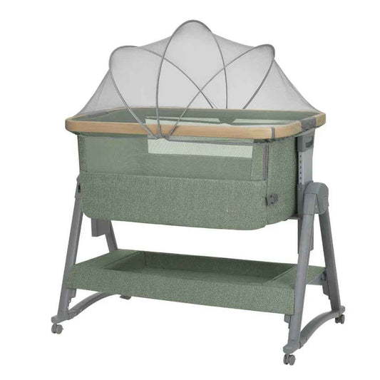 Army green bedside crib with white canopy and mesh sides, wooden rail, and wheels