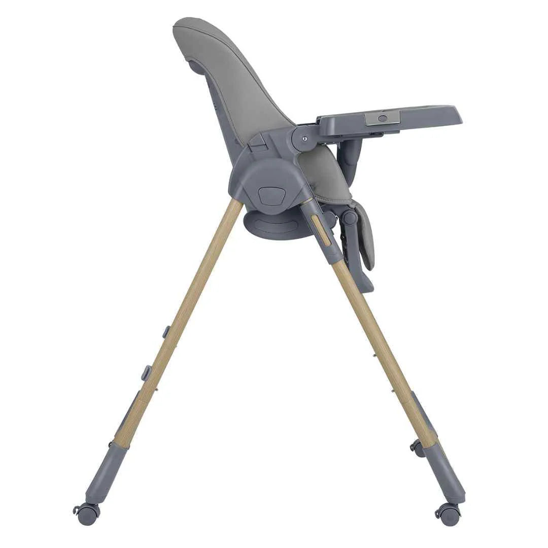 Dark grey high chair viewed from side with reclining seat and footrest