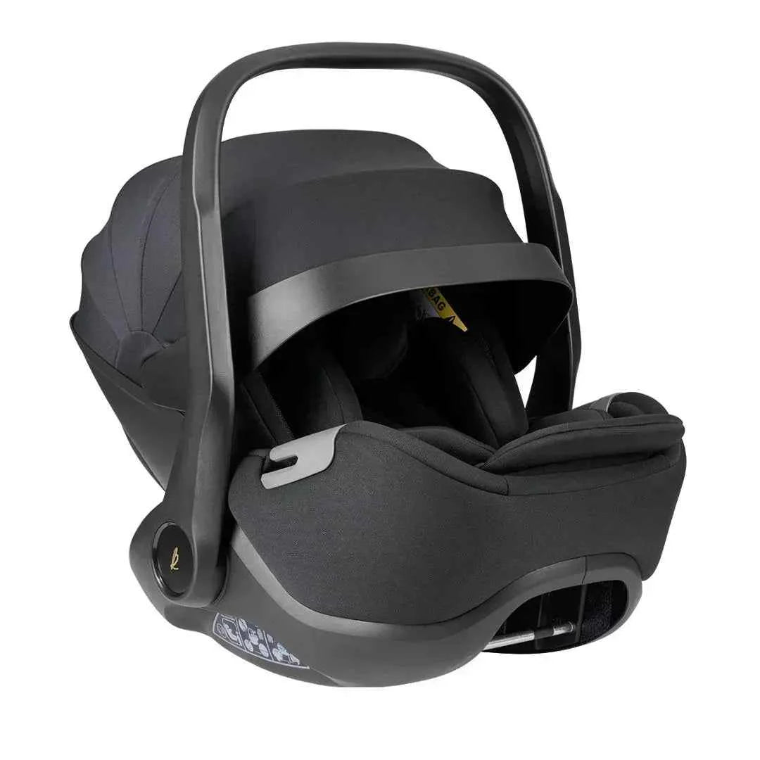 Car seat infant carrier with dark fabric shell and carry handle, front three-quarter view