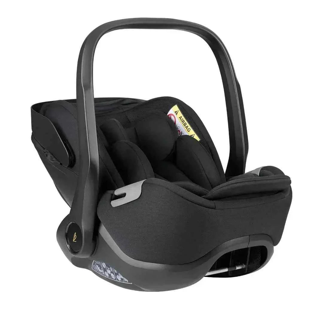 Car seat infant carrier with dark padded insert and carry handle, side view