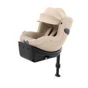 Beige infant car seat with base, side view, padded head support and harness