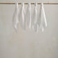 Muslin squares, white cloth squares displayed on a wooden bar with gathered tops