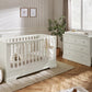 Off-white cot bed with vertical slat rail, viewed from the side
