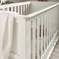 Off-white cot bed side rail and panel with rounded corner detail