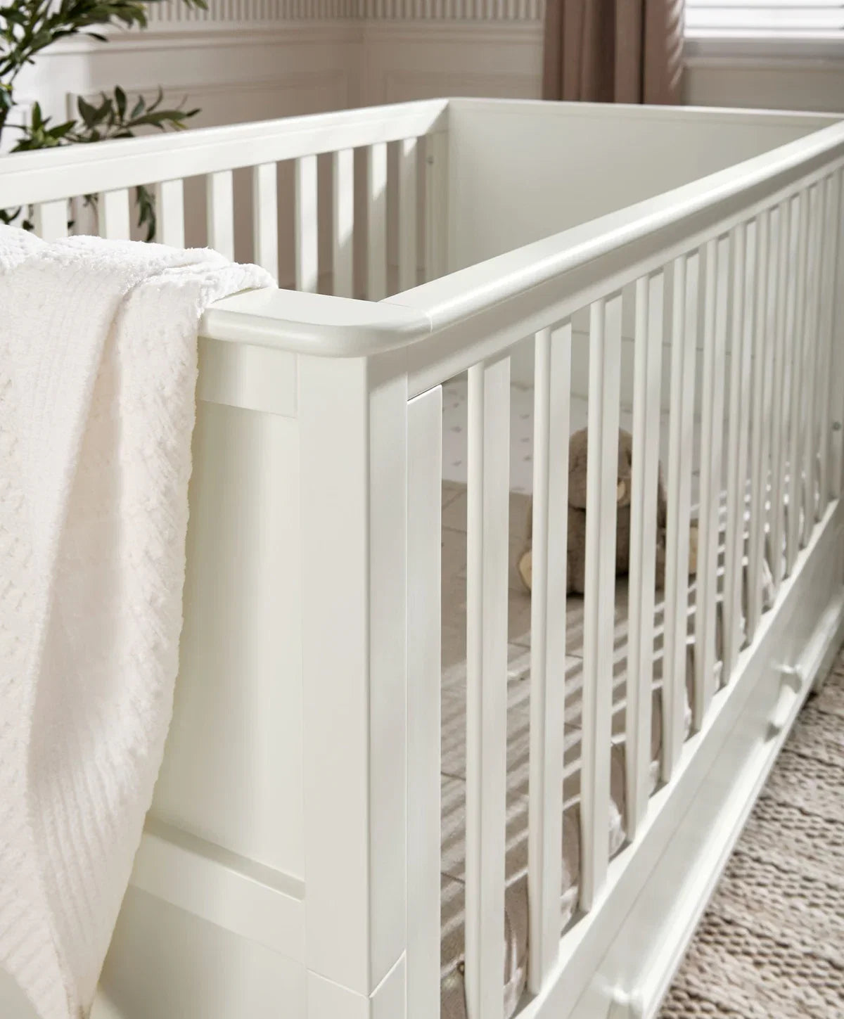 Off-white cot bed side rail and panel with rounded corner detail