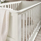 Off-white cot bed side rail with smooth panel and vertical slats