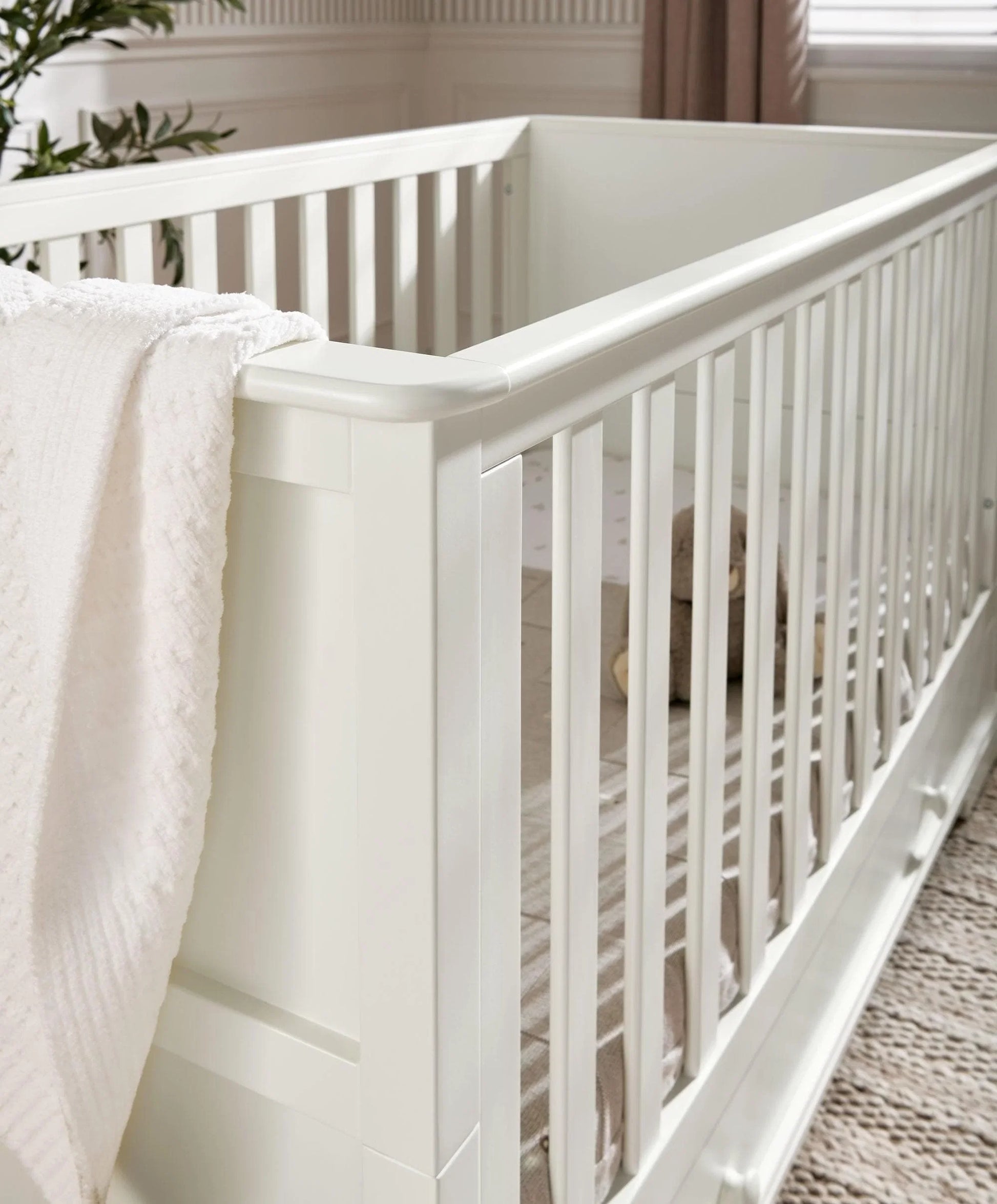 Off-white cot bed side rail with smooth panel and vertical slats