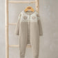 Light beige knitted romper with long sleeves, button front, and teddy bear face motif
