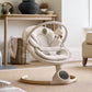 Cream baby swing side view with cushioned seat and dangling toy arch.