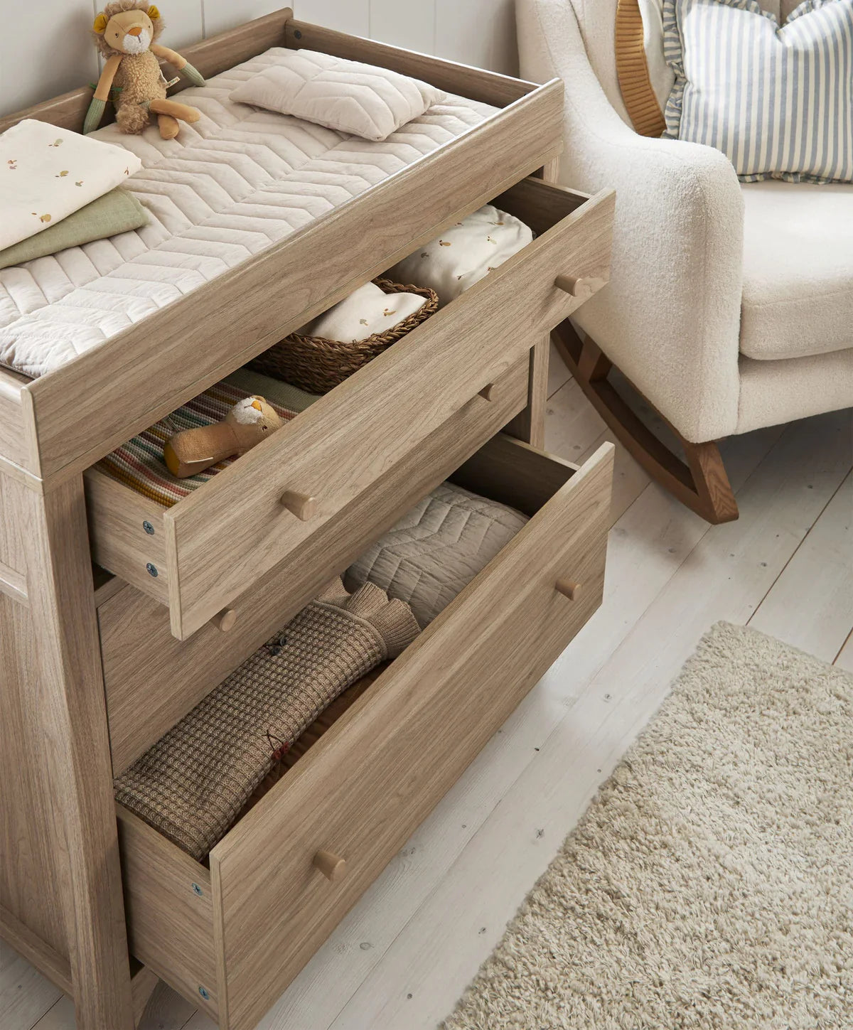 Oak dresser changer with open drawer compartments for storage under the top