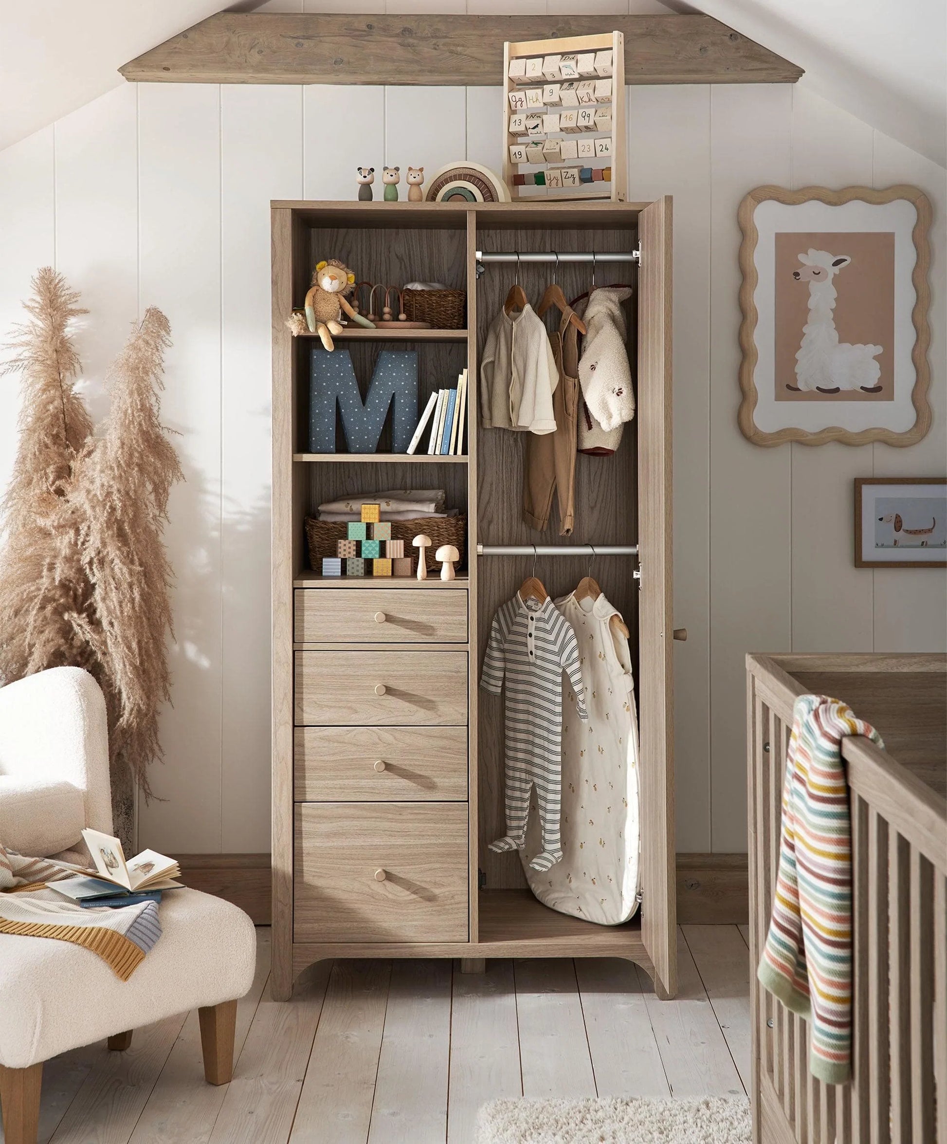 Oak-finish wardrobe with hanging rail, open shelves, and three drawers
