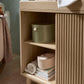 Oak wide dresser changer with open shelf showing baskets and stacked folded linens