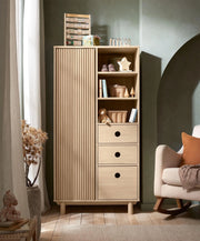 Oak wardrobe with ribbed panel doors, open shelves, and three drawer fronts