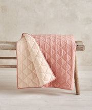 Baby quilt with pink and cream wavy stitched pattern, quilted padded blanket