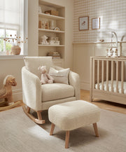 Off-white boucle nursing chair with ottoman stool in nursery, wide view