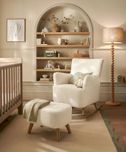 Off-white boucle nursing chair with matching ottoman, rocking base and curved arms