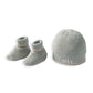 Gray knitted baby beanie with ribbed brim and matching knit booties