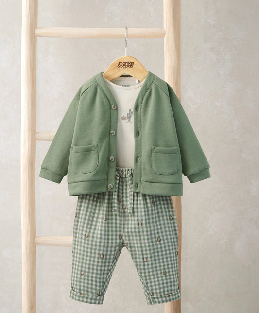 Green button jacket with pockets and green gingham trousers set with white bodysuit.