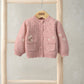 Pink knit cardigan with daisy embroidery, button front and two patch pockets