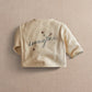 Cream kids jacket with embroidered imagine logo on back and short button placket