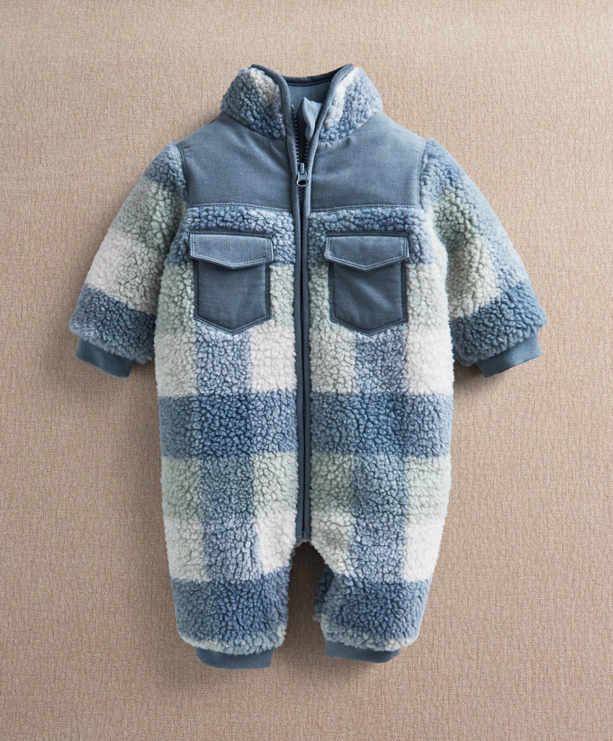 Blue and white fleece pramsuit with zip front and two chest patch pockets