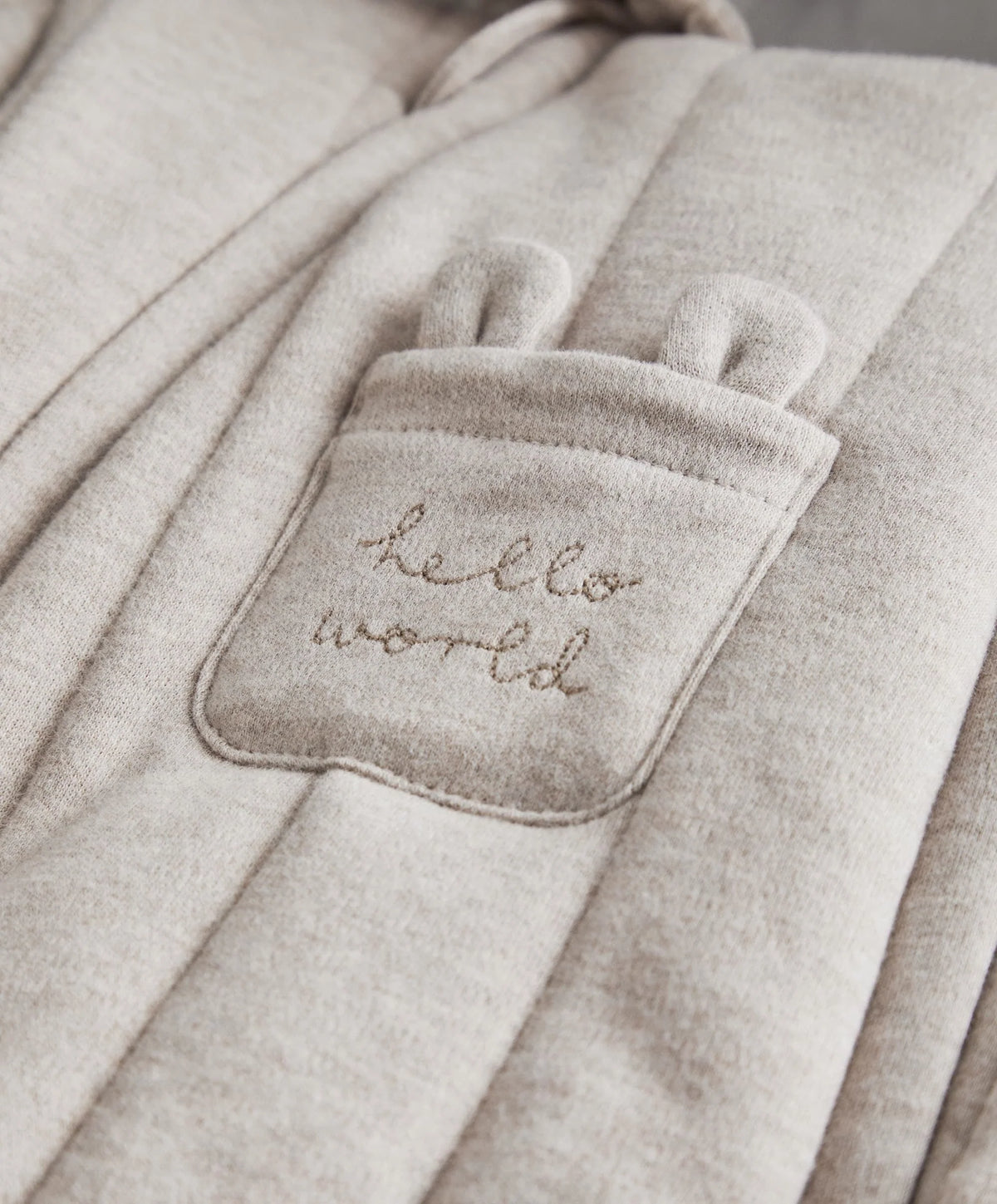 Jersey pramsuit with stitched chest patch, hood, and long sleeves, light gray