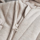 Light gray jersey pramsuit front zip detail with textured stitching and pull
