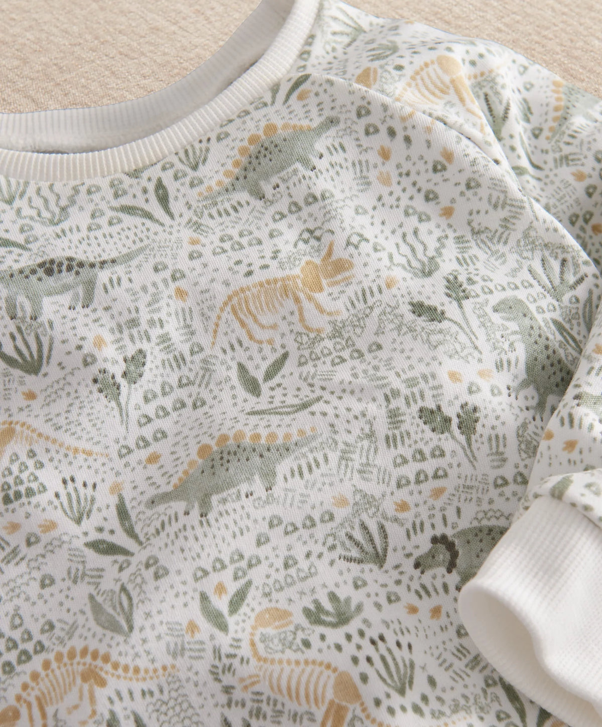Dinosaur jersey pyjamas top close-up with ribbed crew neck and long sleeves
