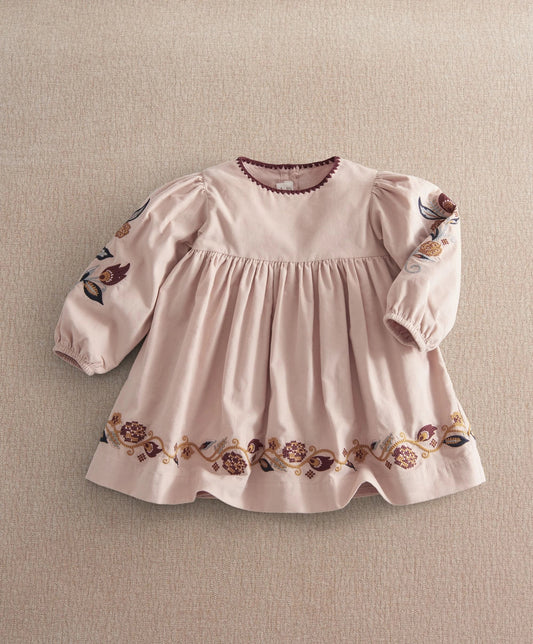 Light pink embroidered corduroy dress with long puff sleeves and floral hem border